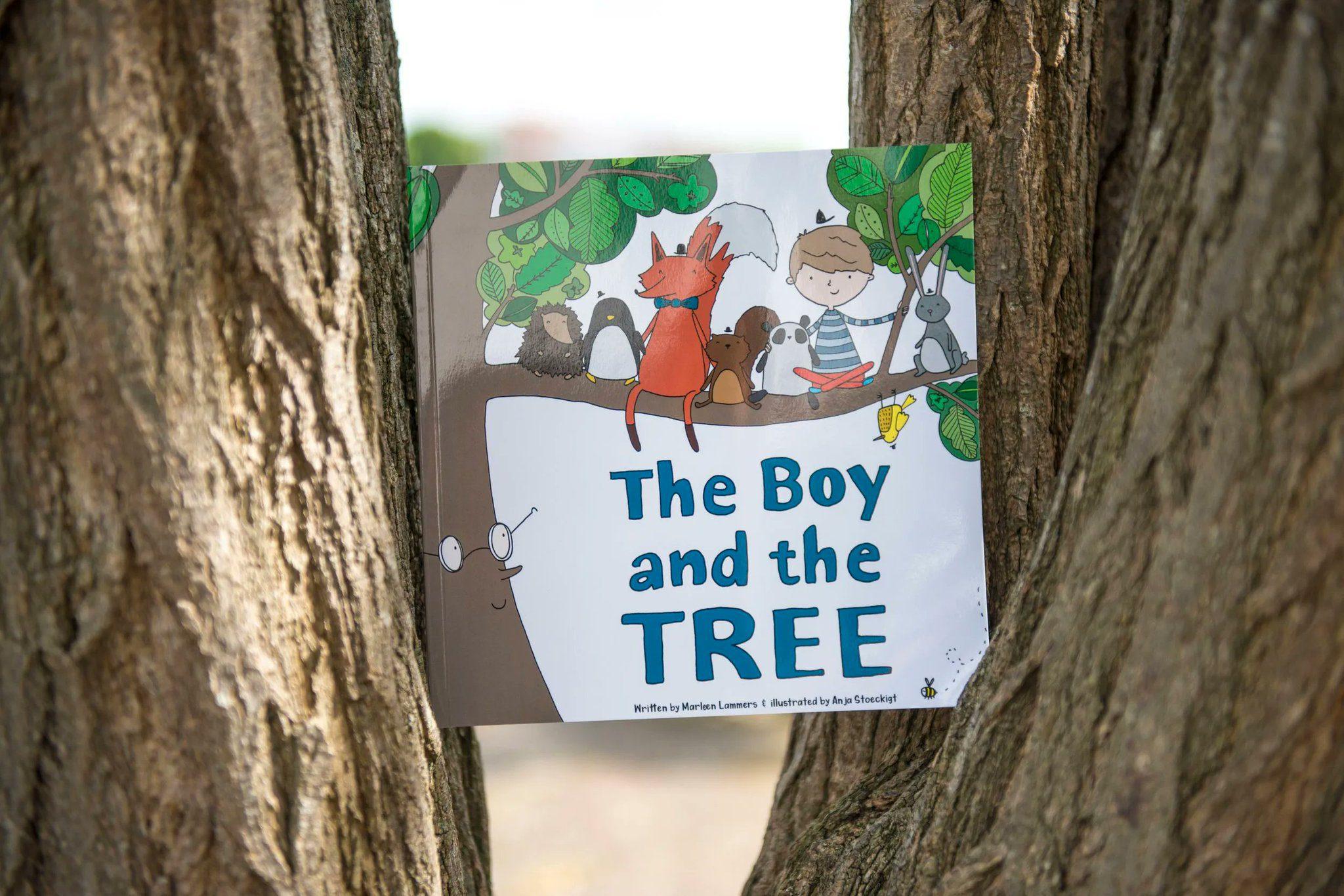 A copy of The Boy and the Tree lodged in a tree