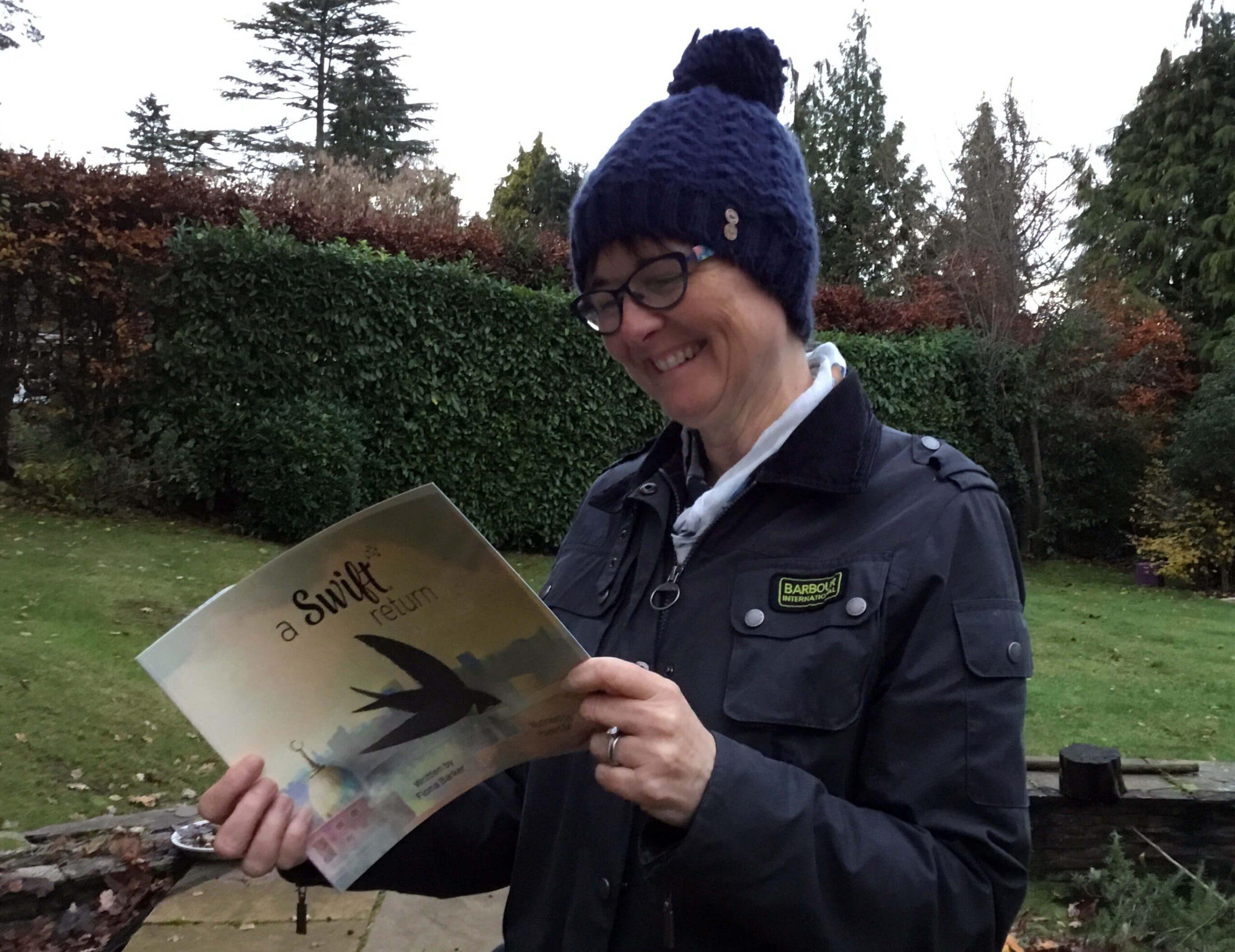 Fiona Barker reads a copy of 'A Swift Return'